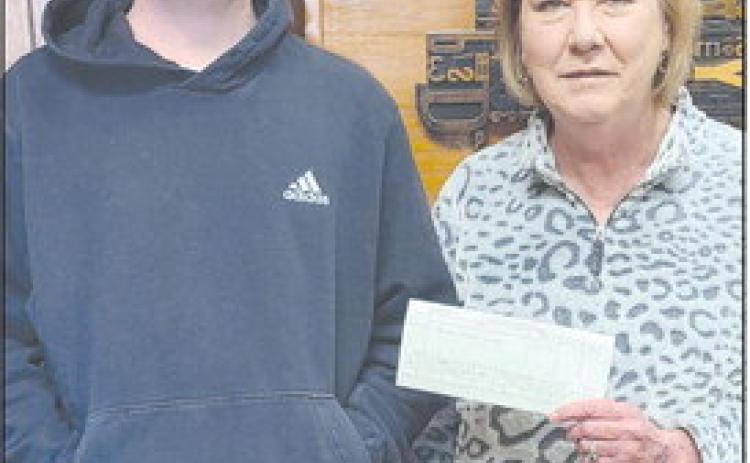 FOOTBALL CONTEST WINNER Paxton Denton was the grand prize winner of the Herald’s annual football contest, with an impressive 70 points. As the winner, he received four tickets to the Goodyear Cotton Bowl at AT&amp;T Stadium in Arlington Jan. 2, and $200 in expense money. Pictured with him is Herald publisher Mary Dudley.