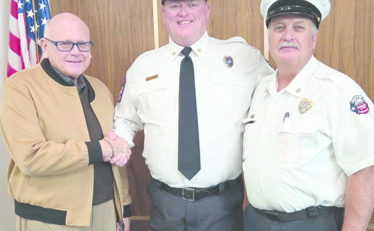 Ed Hanna was sworn in on Dec. 5 as the City of Perryton’s new Fire Department Chief. The brief ceremony came at the end of the retirement reception for outgoing chief Paul Dutcher. Pictured are, from left, Perryton Mayor Kerry Symons, Hanna, and Dutcher.