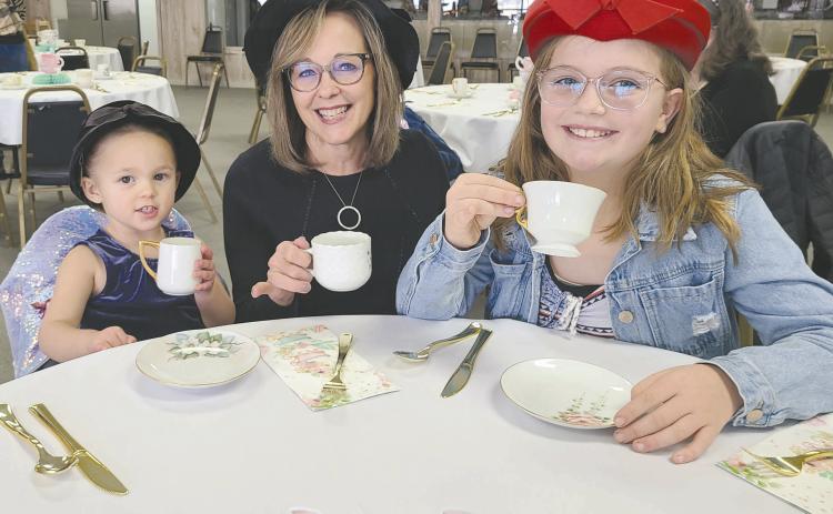 TEA AND SOPHISTICATION Parents, kids, and grandparents of all ages dropped by the Museum of the Plains on Sunday afternoon to enjoy an old-fashioned afternoon tea party. Some 45 residents picked out fancy hats to wear and enjoyed tea, punch, finger sandwiches, cookies, and plenty of good company, as well as checking out the museum’s new display of vintage dolls. Pictured are, from left, Alexia Campbell, age 2, grandma Rhonda Appelhans, and Brystol Appelhans, 10.