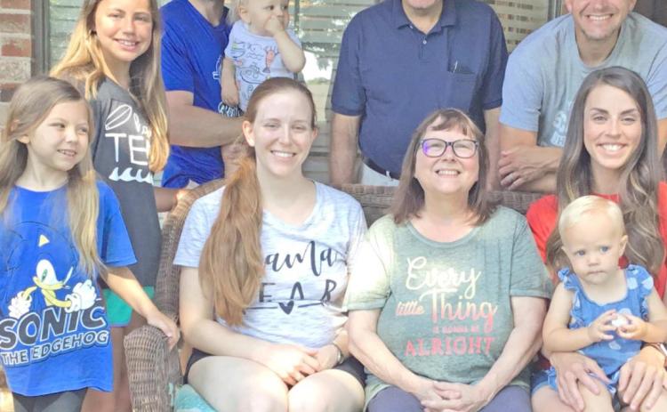 Cindy Shackelford and family: at left, son Scott, his wife Kami and daughters Emma, Zoey and Saylor; and at right, son Ben and his wife Annie with son Caleb; and behind her, husband Danny