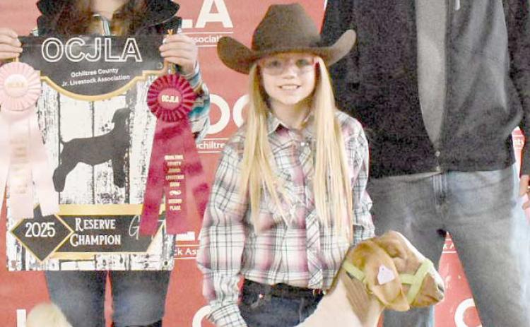 At the Ochiltree County Junior Livestock Show and Sale on Jan. 17-18, Madeleine Jumper took home the award for Reserve Grand Champion Goat. Her animal was purchased by Perryton Realty. Pictured are, from left, Amelia Jumper, Madeleine Jumper, and Bryce Hale. ( Photo credit: Morgan Dudley)
