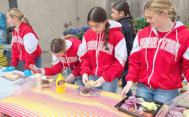 PJH CHEERLEADERS HOLD BURGER FUNDRAISER— Perryton Junior High School’s Cheerleaders held a hamburger fundraiser last week at United Supermarkets. Participants could order a fresh-cooked hamburger with all the fixins grilled up by the cheerleaders and their sponsors. Proceeds from the fundraiser will help fund new uniforms and equipment, trips, and much more.