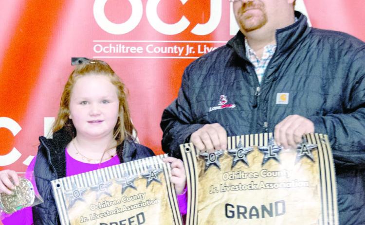 At the Ochiltree County Junior Livestock Show and Sale on Jan. 16-17, the prize for Grand Champion Sheep went to Bryar Herod. His animal was bought by Bank of Western Oklahoma-Woodward . Pictured are, from left, Bryar Herod and Matthew Gillispie. ( Photo credit: Hailey Clark of Hailey Renee Photography)