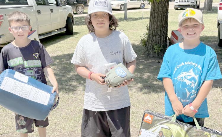 Enthusiastic young fishing fans came out for the Children’s Fishing Tournament at Lake Fryer and Wolf Creek Park at the beginning of June. Pictured are, from left, the top winners in the category for kids ages 7-10, Carson Barkley (third place), Christian Shipley (second place), and Slade Savard (first place).
