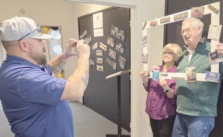 PHOTOS FOR POSTERITY— Visitors from around the area turned out to celebrate the Museum of the Plains’ 50th anniversary on Sunday, Nov. 16, and to enjoy the exhibition on the museum’s history. Pictured taking some photos during the event are, from left, J.W. Brown, and Rita and Bill Mac Tregellas.