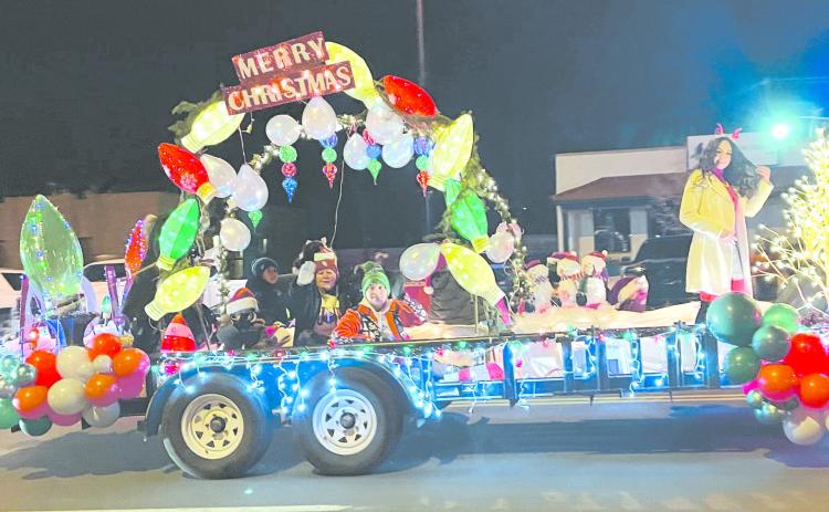 PARADE OF LIGHTS The Perryton-Ochiltree Chamber of Commerce hosted a Christmas Parade of Lights downtown on Dec. 3. The parade ran down Main Street from Ninth to Brillhart, as vehicles and floats decked out in festive Christmas lights entertained the large crowd on hand and worked to fire up everyone’s holiday spirit. Pictured above is Victory Christian Academy’s entry in the event.