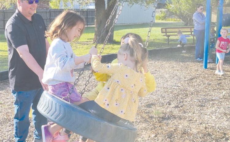 SWINGING IN THE TIRE SWING